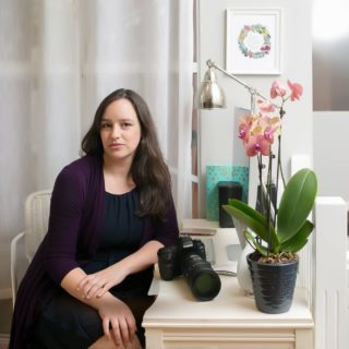 Paris Lenahan Photography Profile Photo Profile photo for photographer, Paris Lenahan. She is sitting at a desk with a camera.